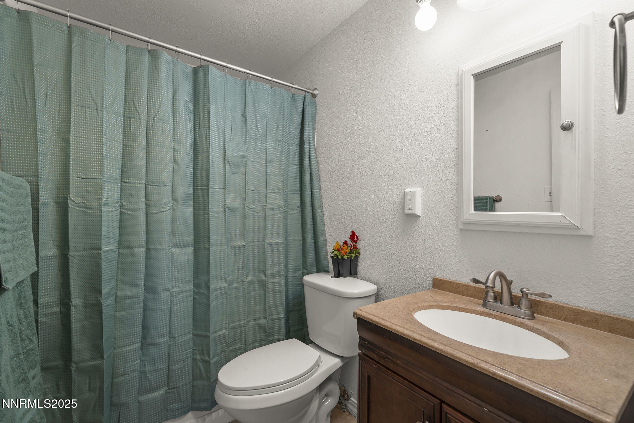 10005 Sagewood Drive Reno, NV 89506 - Photo 23 of 43 a bathroom with a granite countertop sink toilet a mirror and shower