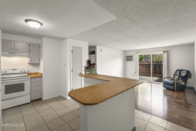 a kitchen with granite countertop a stove and a sink