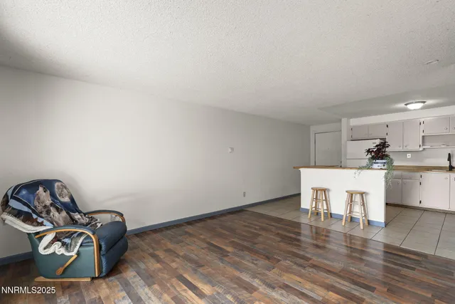 a view of a workspace with wooden floor