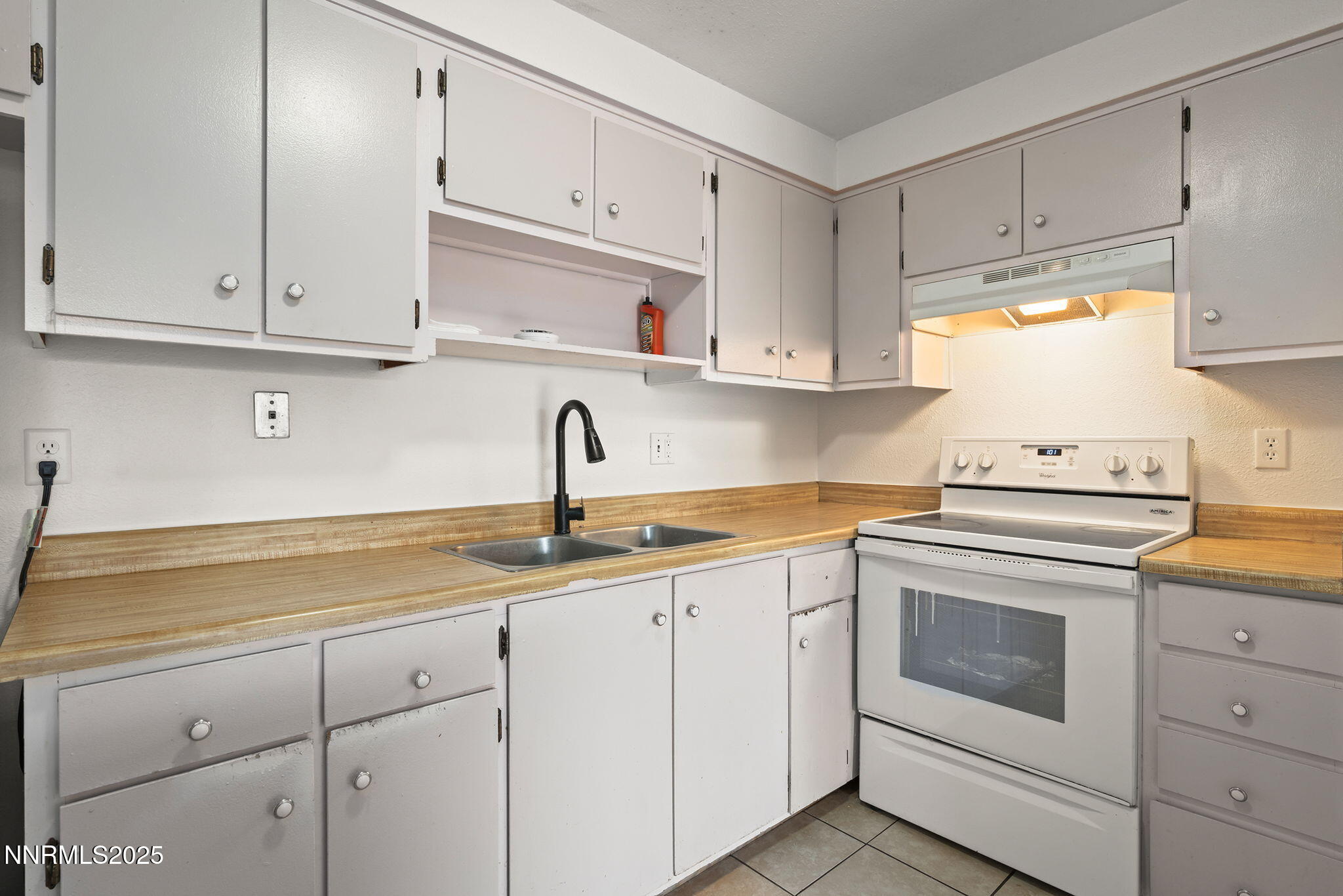 10005 Sagewood Drive Reno, NV 89506 - Photo 28 of 43 a kitchen with white cabinets and white appliances