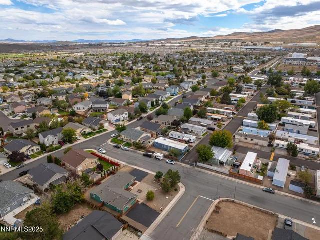 an aerial view of residential houses with city view