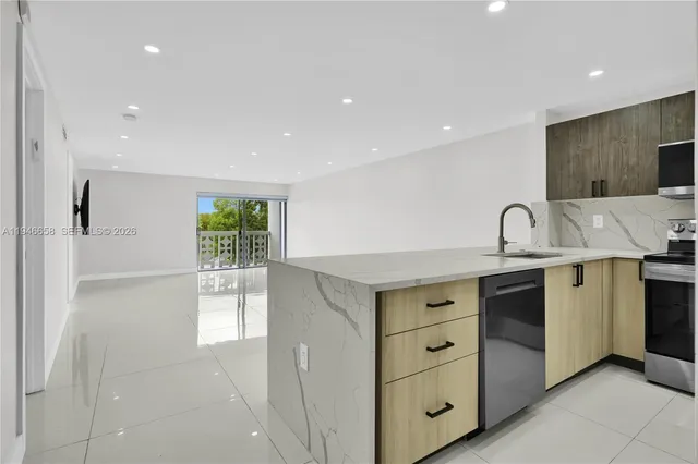 a kitchen with cabinets appliances and a sink
