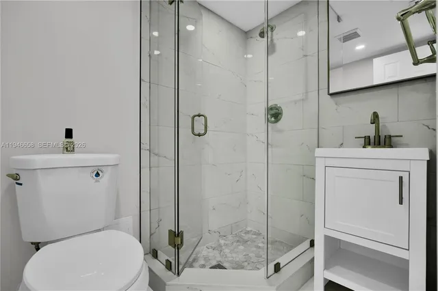 a bathroom with a toilet a sink and shower