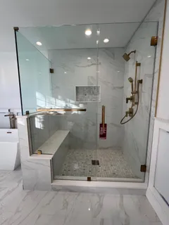 a bathroom with a granite countertop sink a mirror and shower
