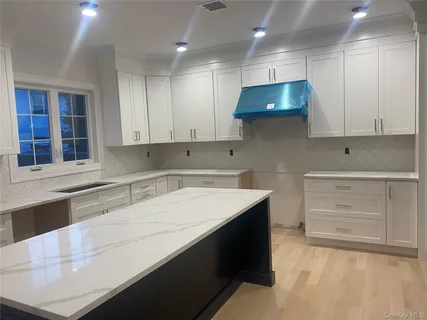 a kitchen with a sink a stove and cabinets