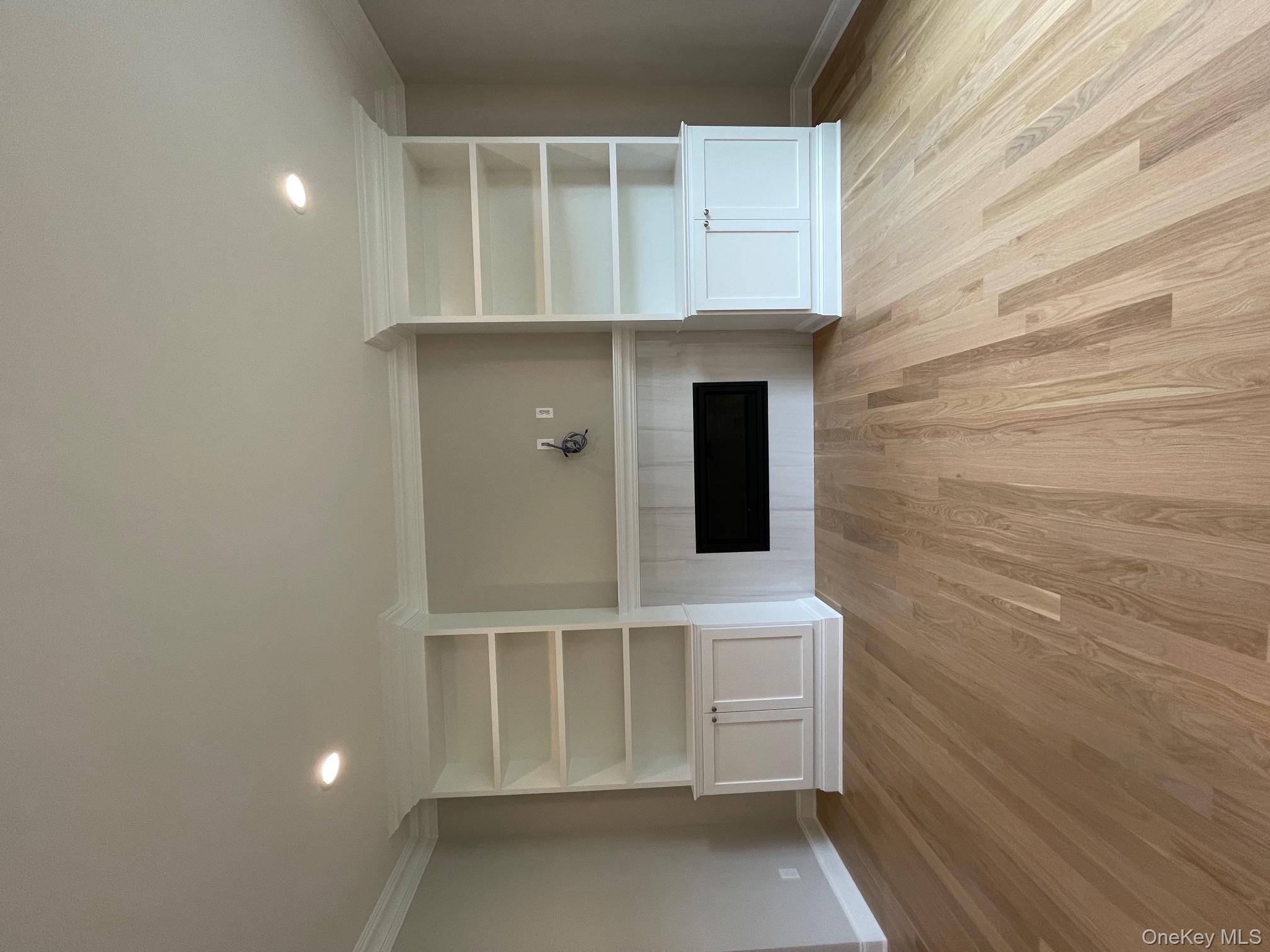 7 Greenway Circle Syosset, NY 11791 - Photo 4 of 10 Unfurnished living room featuring light wood-style floors, a fireplace, built in shelves, recessed lighting, and crown molding