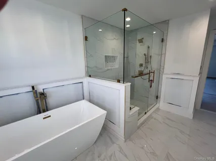 a bathroom with a tub and shower