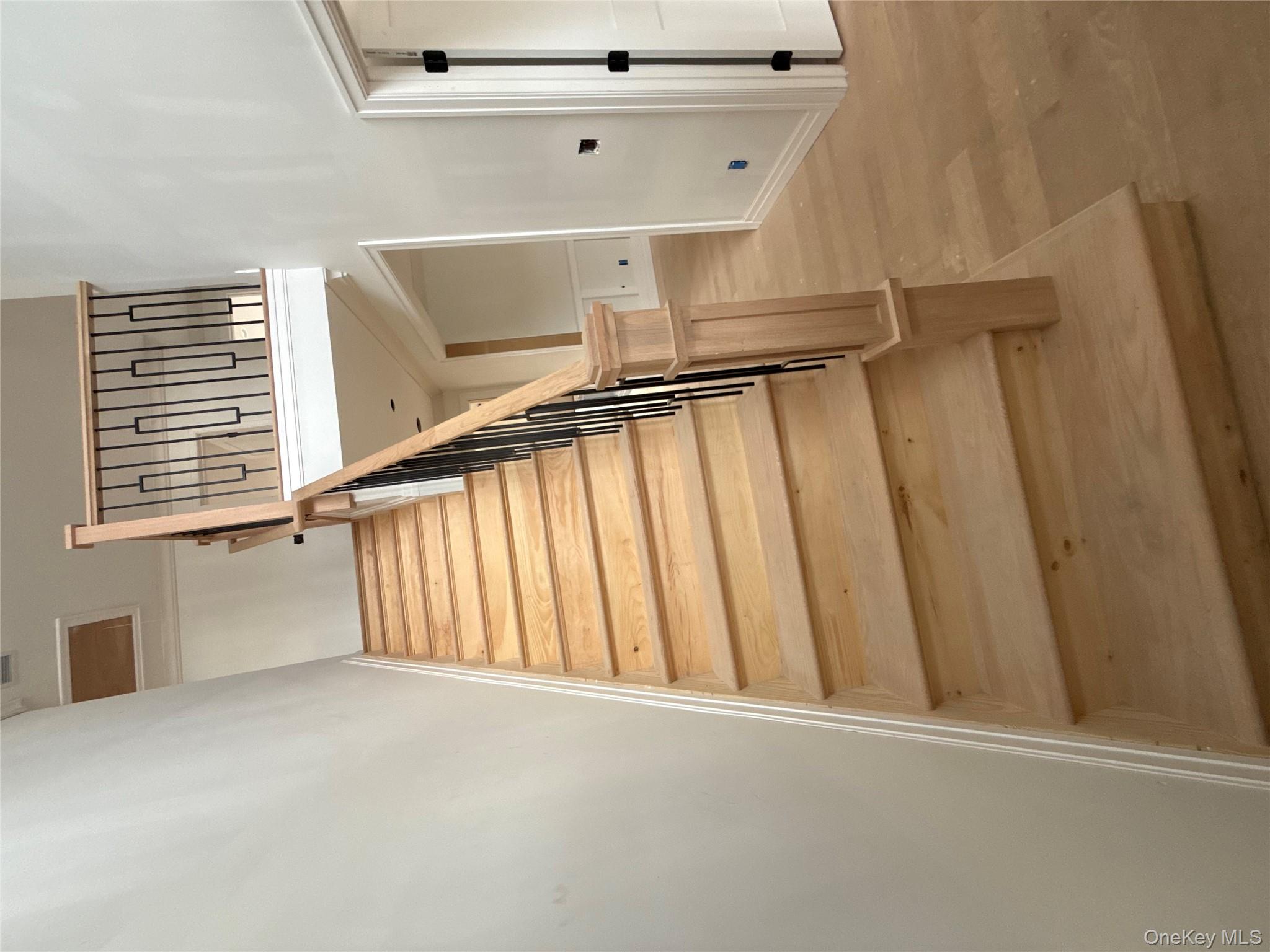 7 Greenway Circle Syosset, NY 11791 - Photo 5 of 10 Stairs featuring wood finished floors and baseboards