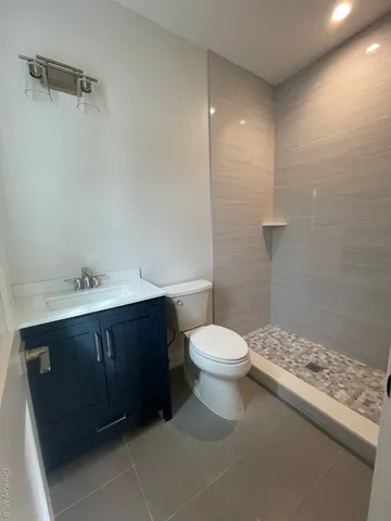 a bathroom with a sink vanity and toilet