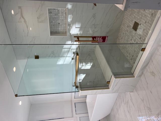 7 Greenway Circle Syosset, NY 11791 - Photo 6 of 10 Full bathroom with a freestanding tub, marble finish flooring, a marble finish shower, recessed lighting, and wainscoting