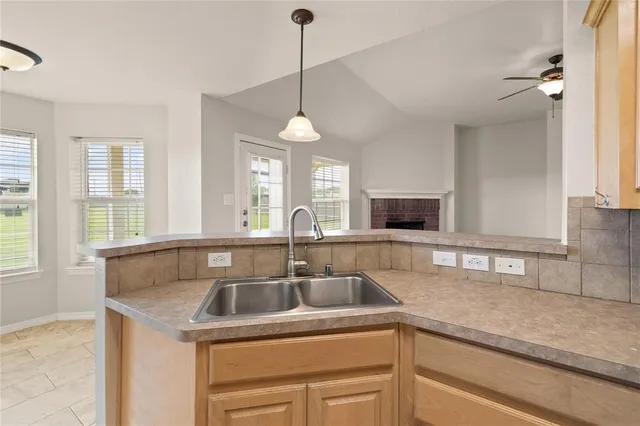 a kitchen with a sink and a window