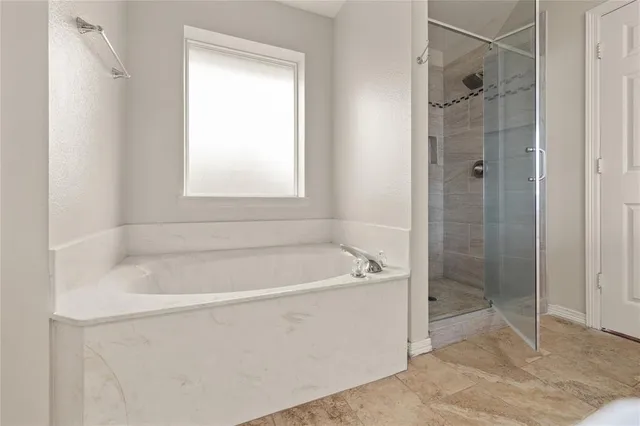 a white bath tub sitting next to a shower