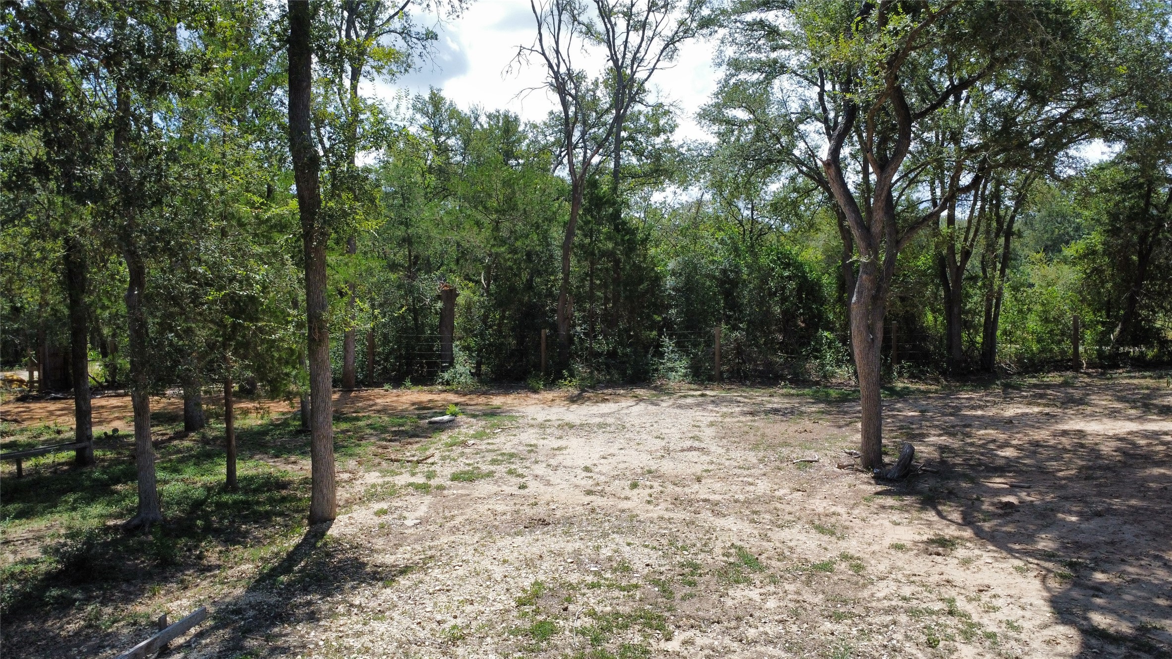 959 Carter Road Dale, TX 78616 - Photo 1 of 20 Mature trees frame a spacious, cleared building site on this beautiful wooded property.
