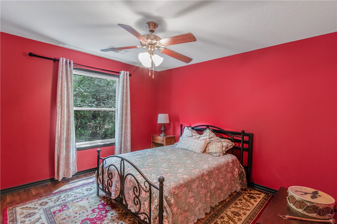 9997 Calhoun Road Bryan, TX 77808 - Photo 17 of 50 a bedroom with a bed and a window