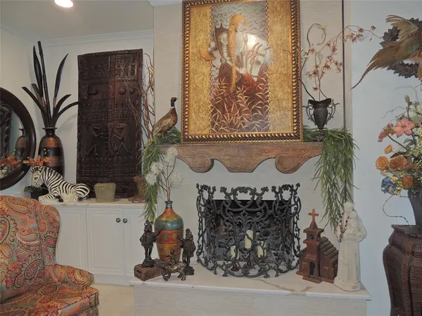 a living room with fireplace furniture and a large window
