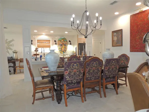 a view of a dining room with furniture and chandelier