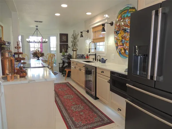 a very nice looking dining room with a rug and a chandelier