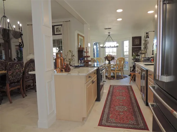 a view of a dining room with furniture and chandelier