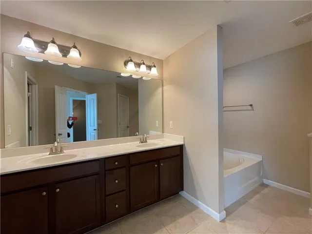 a bathroom with a double vanity sink and a mirror