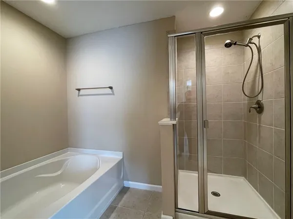 a bathroom with a tub and shower