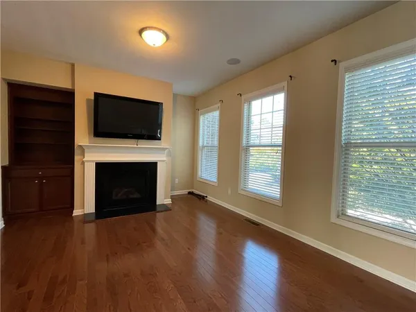 a view of a livingroom with a fireplace a window and a fireplace