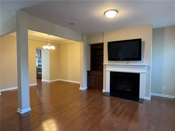 a view of a livingroom with a fireplace wooden floor and fire place