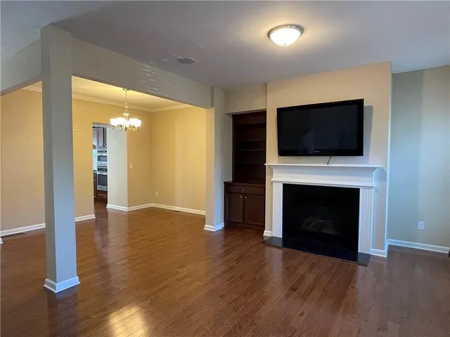 a view of a livingroom with a fireplace wooden floor and fire place