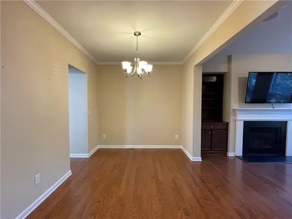 wooden floor in an empty room with a fireplace