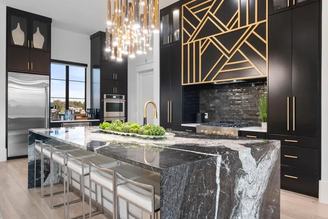 a kitchen with stainless steel appliances granite countertop a sink and cabinets