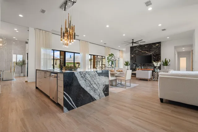 a living room with furniture and kitchen view