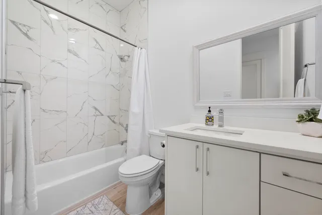 a bathroom with a sink toilet and shower