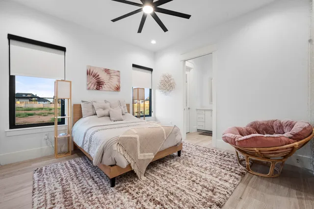 a bedroom with a bed and a painting on the wall