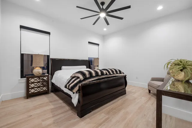 a bedroom with a bed and a chandelier