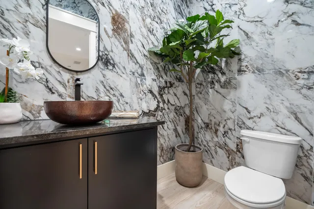 a bathroom with a toilet a sink and a mirror