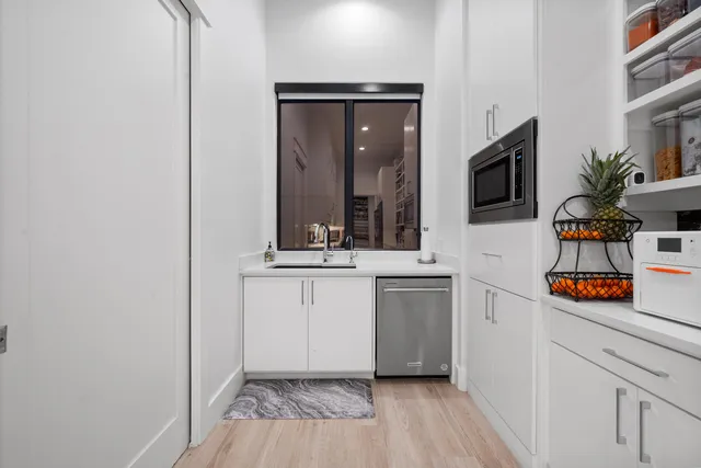 a hallway with cabinets and wooden floor