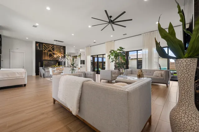 a living room with furniture a ceiling fan and a rug