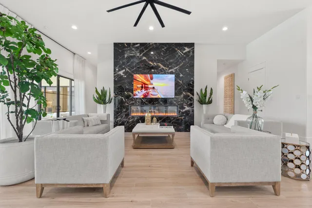 a living room with furniture a fireplace and a flat screen tv