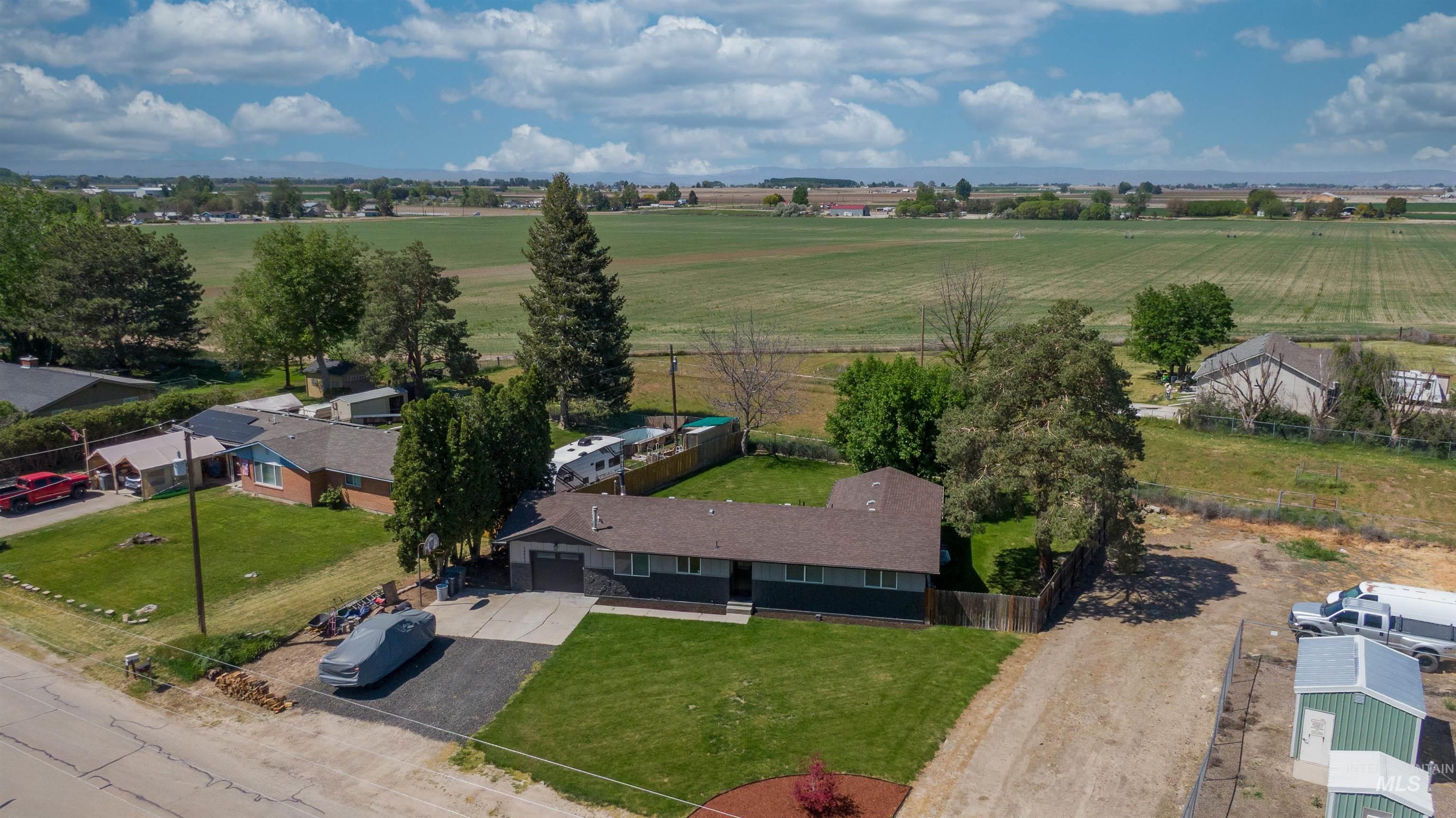 20803 Friends Road Greenleaf, ID 83626 - Photo 3 of 39 Single-story residence featuring a dark gray exterior with a contrasting lighter gray garage door