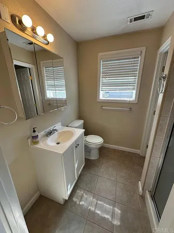 a view of a bathroom with a sink a toilet and mirror