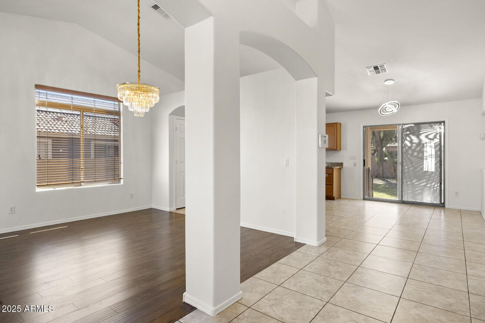 3297 East Warbler Road Gilbert, AZ 85297 - Photo 4 of 32 a view interior of a house wooden floor and a chandelier