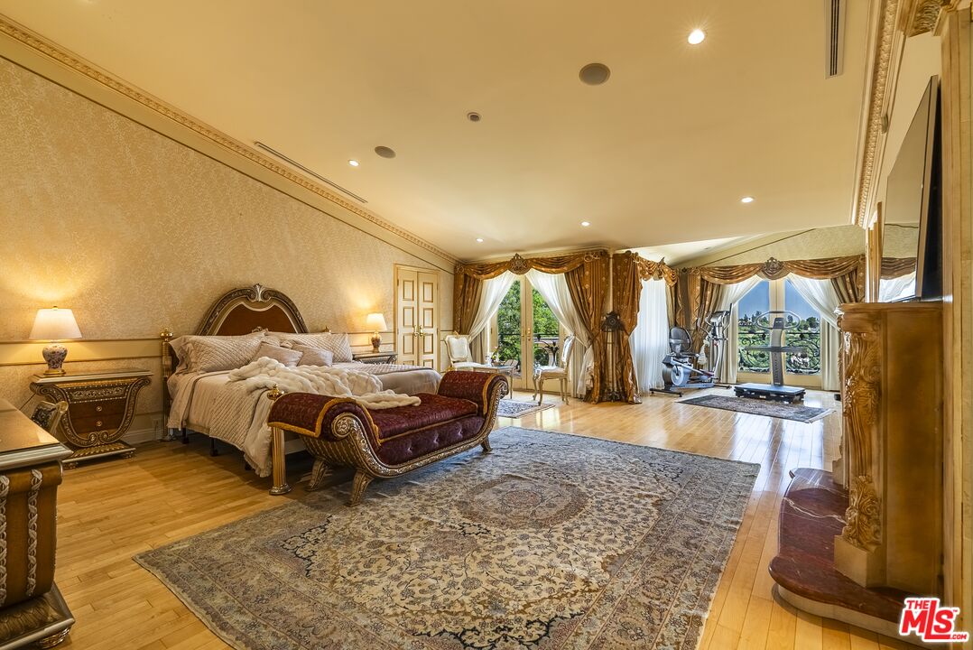 2716 Casiano Road Los Angeles, CA 90077 - Photo 12 of 21 a bedroom with a bed and wooden floor