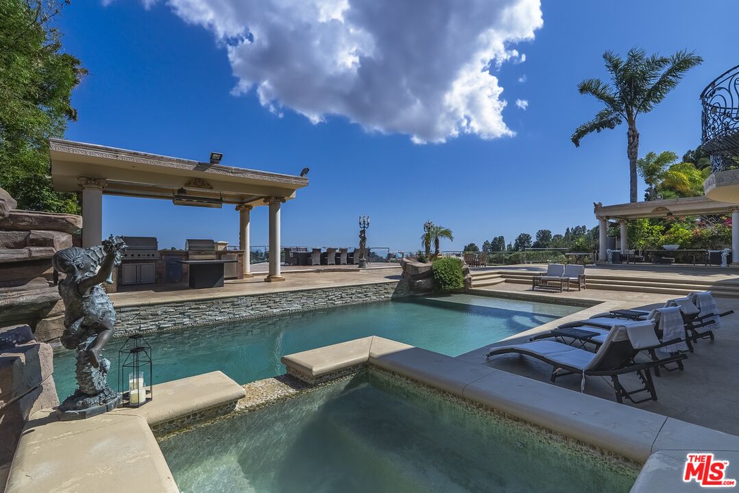 2716 Casiano Road Los Angeles, CA 90077 - Photo 16 of 21 a view of a swimming pool with outdoor seating