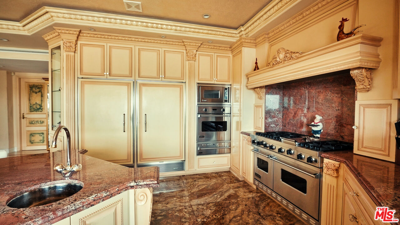 2716 Casiano Road Los Angeles, CA 90077 - Photo 8 of 21 a kitchen with stainless steel appliances granite countertop a stove and a refrigerator