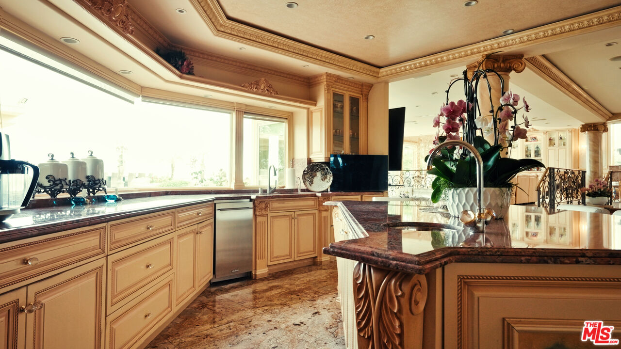 2716 Casiano Road Los Angeles, CA 90077 - Photo 10 of 21 a kitchen with white cabinets and sink