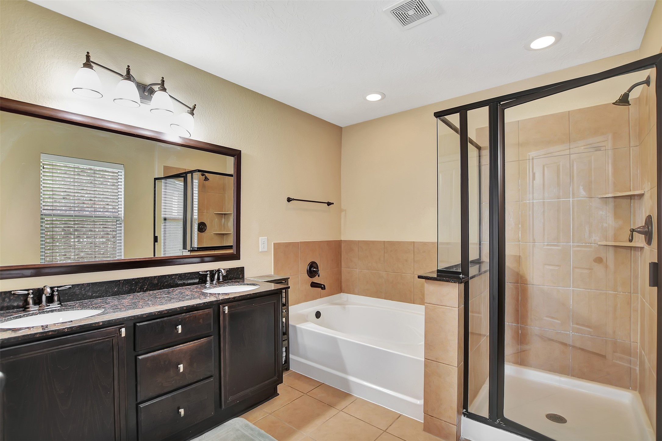 9706 Lockhart Reach Lane Humble, TX 77396 - Photo 14 of 25 a bathroom with a tub a sink and mirror