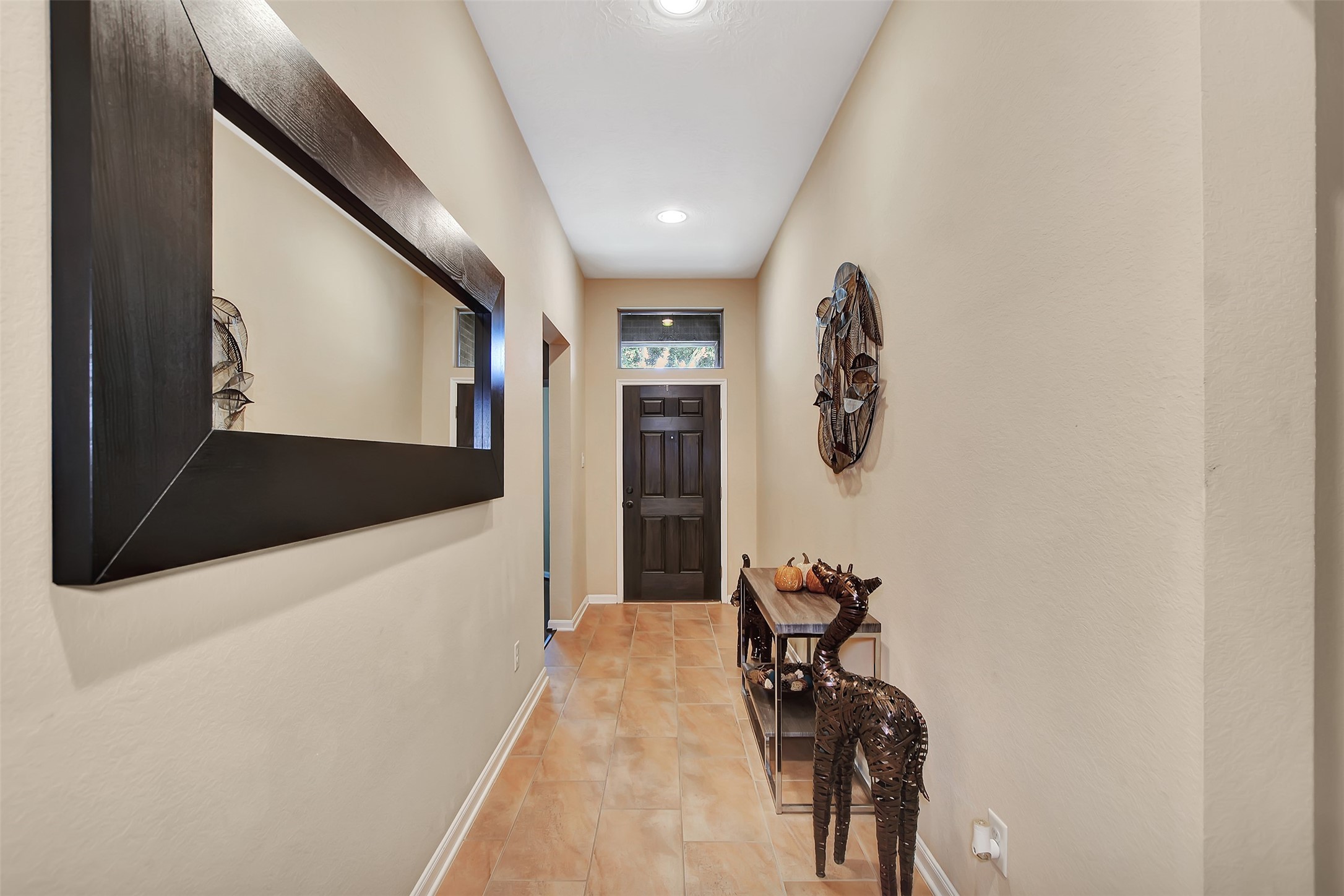 9706 Lockhart Reach Lane Humble, TX 77396 - Photo 3 of 25 a hallway with table and a large mirror