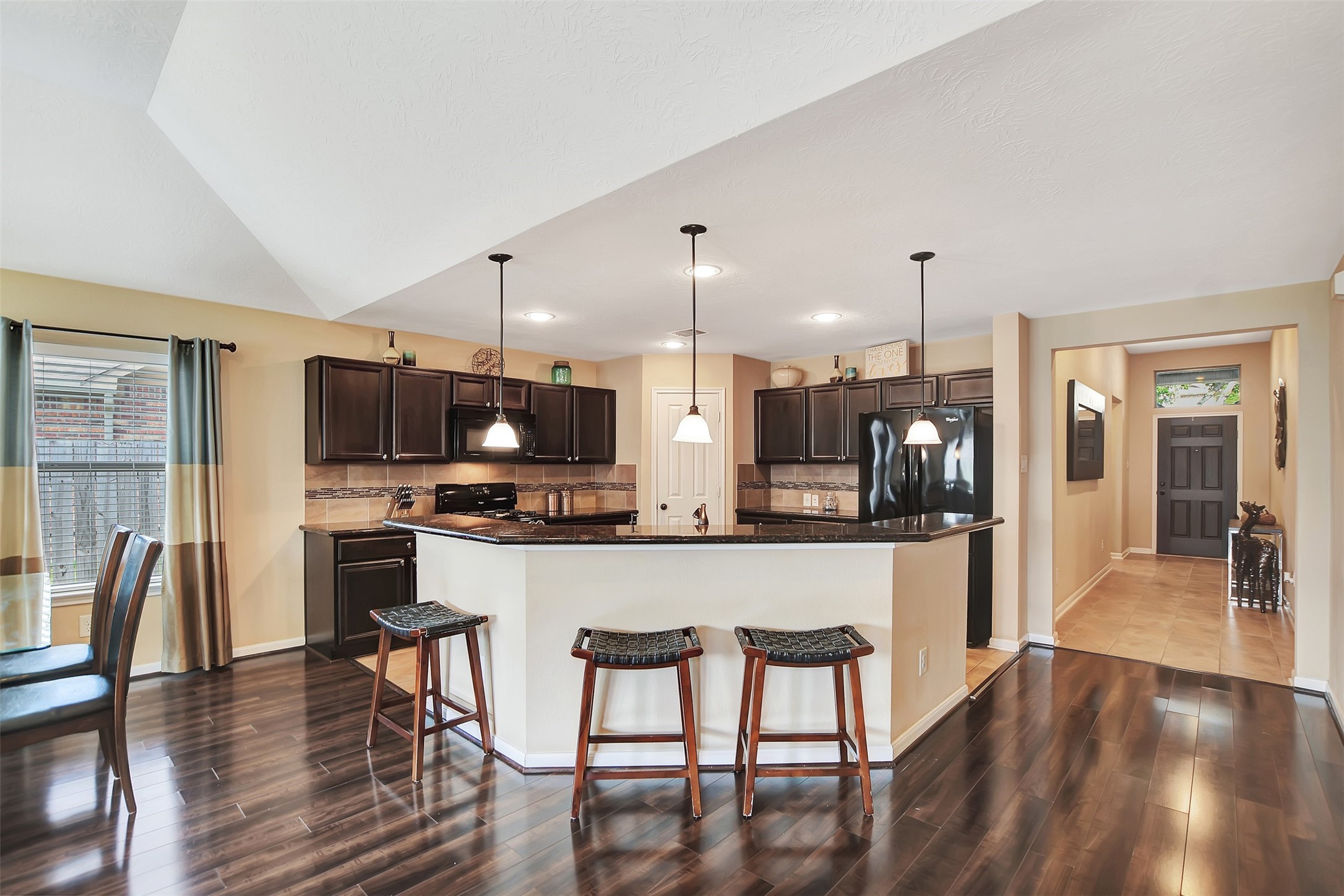 9706 Lockhart Reach Lane Humble, TX 77396 - Photo 6 of 25 a large kitchen with a table and chairs