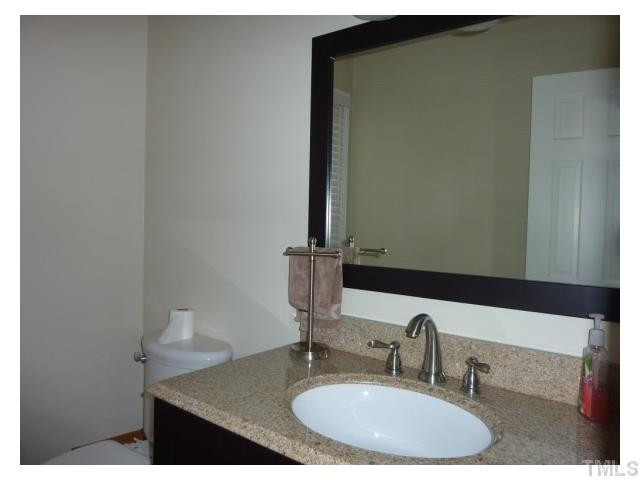 5407 Fortunes Ridge Drive Durham, NC 27713 - Photo 17 of 22 a bathroom with a sink and a mirror