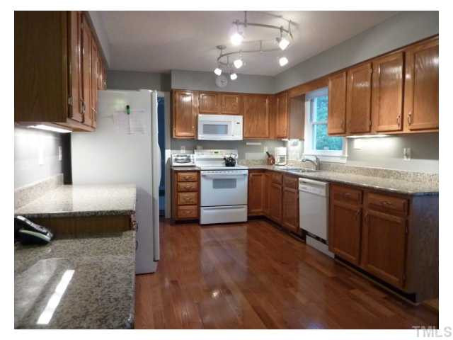 5407 Fortunes Ridge Drive Durham, NC 27713 - Photo 2 of 22 a kitchen with stainless steel appliances granite countertop a sink dishwasher a stove and a refrigerator with wooden floor