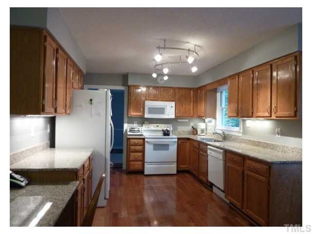 5407 Fortunes Ridge Drive Durham, NC 27713 - Photo 4 of 22 a kitchen with a sink stainless steel appliances and cabinets